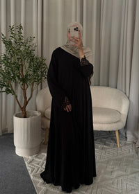 Full-length view of the Nayla Lace Abaya Black with flowy fit and lace cuffs