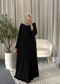 Full-length view of the Raya Flow Abaya Black with a relaxed modest fit