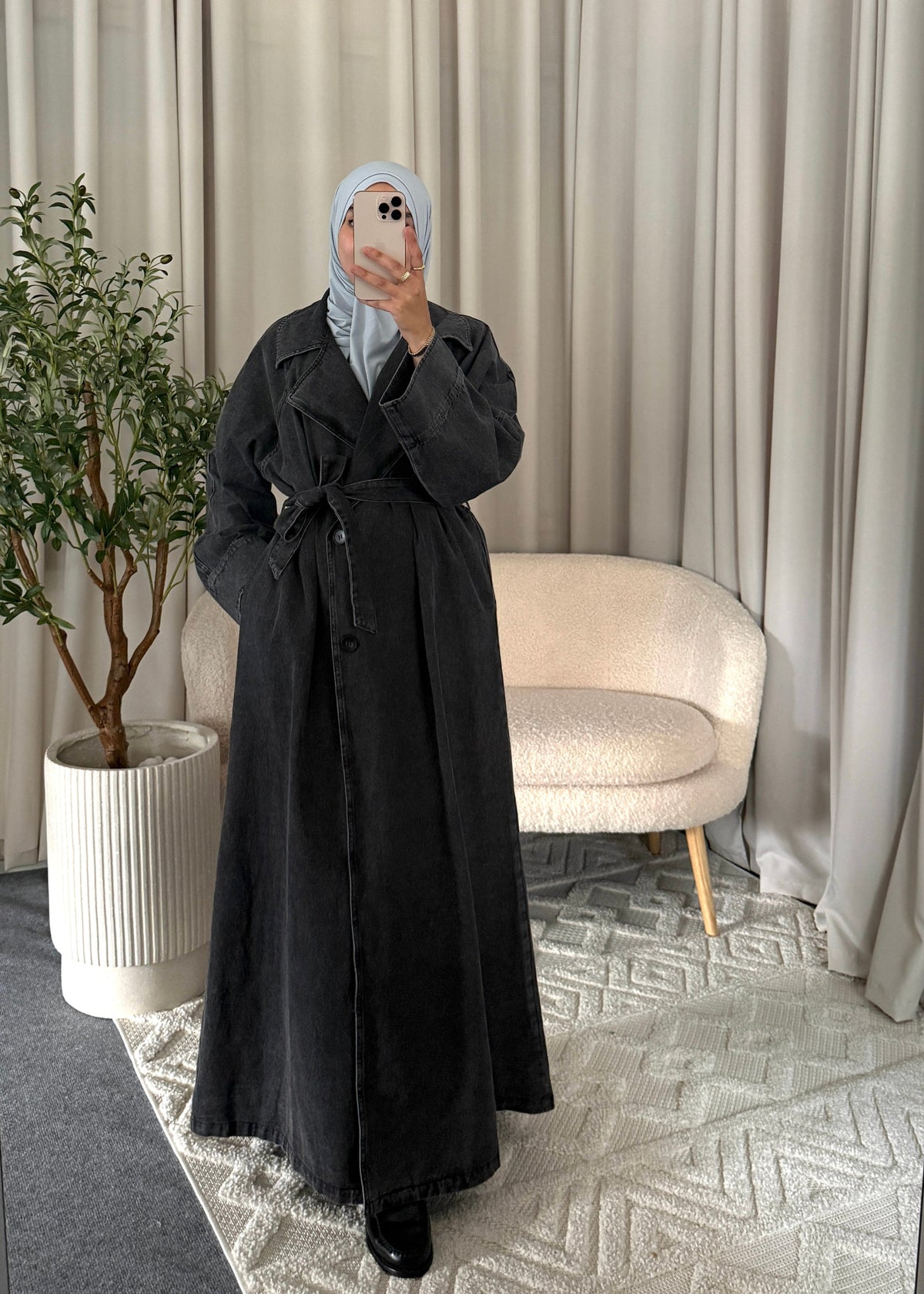 Full-length view of the Zaya Denim Trenchcoat Black styled as a modest autumn look